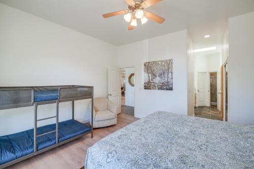 a bedroom with a bunk bed and a ceiling fan at Serene Pine Mountain Club Home with Pool Access! in Pine Mountain Club
