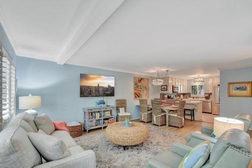 a living room with couches and a dining room at Old Bay Hideaway in East End