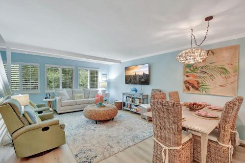 a living room with a table and chairs at Old Bay Hideaway in East End