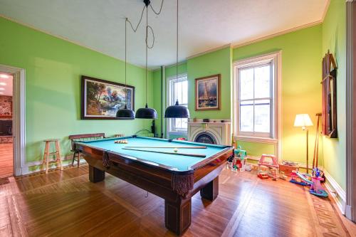a room with a pool table and a fireplace at Historic Chambersburg Home with Pool and Game Rooms! in Chambersburg
