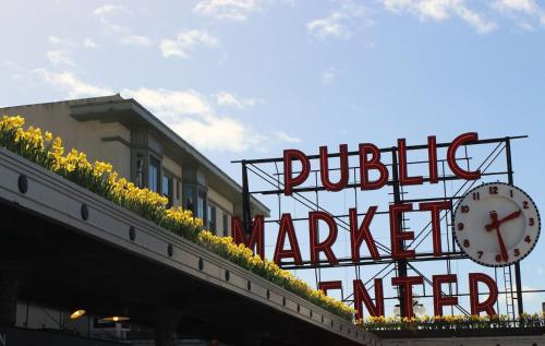 a sign for a public market with a clock on it at New modern Nordic style home, View, Rooftop deck in Seattle