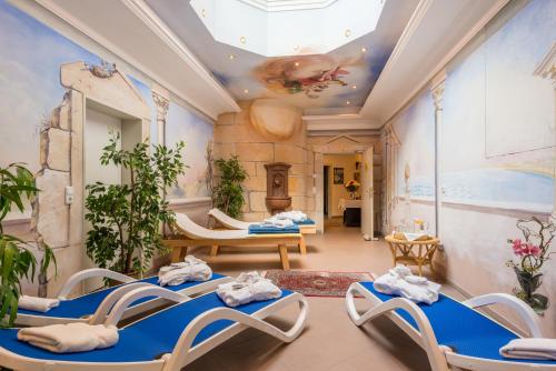 a room with blue chairs and a ceiling at Hotel Rheinischer Hof in Garmisch-Partenkirchen