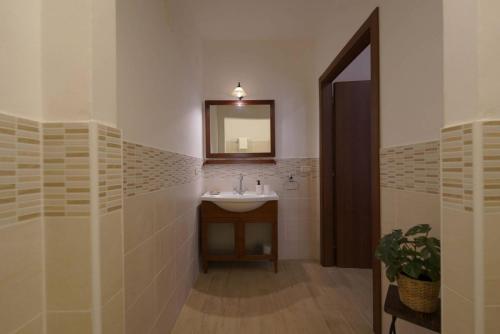 a bathroom with a sink and a mirror at SyracuseApartments Antica Dimora in Siracusa