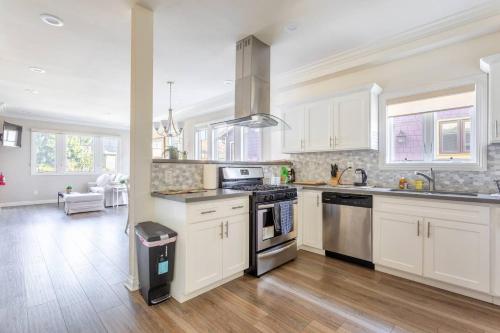 a kitchen with white cabinets and stainless steel appliances at Shared Living Los Angeles (South K-Town) in Los Angeles