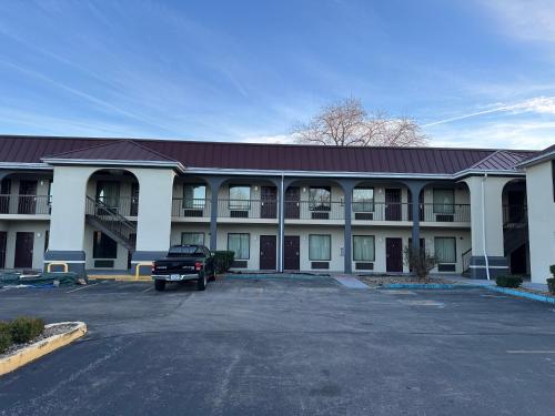 a large building with a truck parked in a parking lot at Quality Inn in Ashland