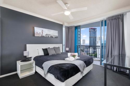 a bedroom with a bed and a large window at Chevron Renaissance Ocean Views - Self Contained, Privately Managed Apartments in Gold Coast