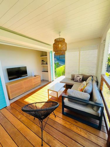 a living room with a couch and a table at Villa Ti Lagon in Sainte-Luce