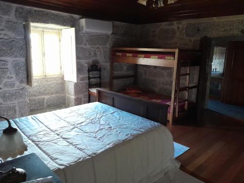 a bedroom with two bunk beds and a window at Cantinho da Tilde in Fafe