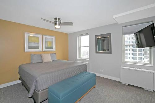a bedroom with a bed and a flat screen tv at Hotel District Downtown Atl 1 Bedroom Condo in Atlanta