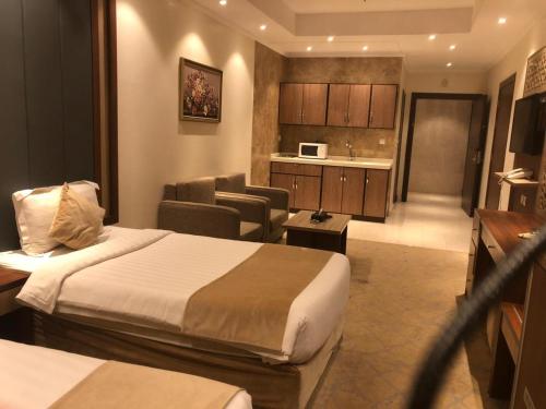 a hotel room with two beds and a living room at درة العروس للوحدات السكنية المفروشة in Jeddah