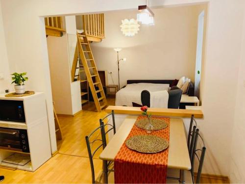 a living room with a bed and a table and chairs at Downtown Apartment Bianca in Bratislava