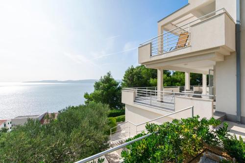 a house with a view of the ocean at Apartments Olive sea view in Mimice
