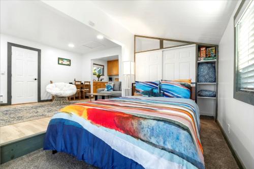a bedroom with a colorful bed and a dining room at Sonoma Coast Retreat - Water Views BBQ WIFI in Bodega Bay