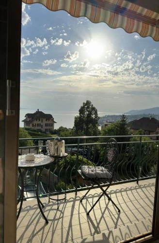 a view from a balcony with a table and chairs at Villa Montreux in Montreux