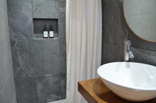 a bathroom with a white sink and a mirror at Hotel CASA PETRI in Ensenada