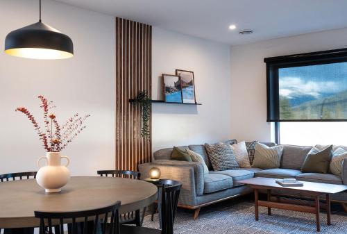 a living room with a couch and a table at Villa 23 Cabot Peaks by Revelstoke Vacations in Revelstoke