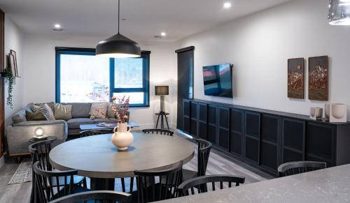 a living room with a table and chairs at Villa 23 Cabot Peaks by Revelstoke Vacations in Revelstoke