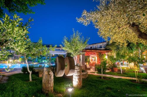 a house with a swimming pool in a yard at Hotel Europa Olympia in Olympia