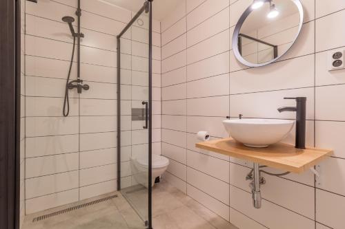 a bathroom with a sink and a shower at LIPNO Moss Apartment in Lipno nad Vltavou