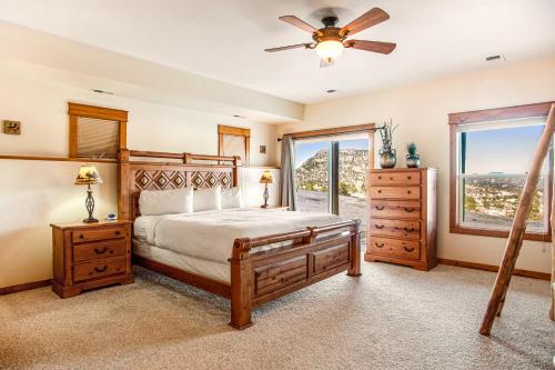 a bedroom with a bed and a ceiling fan at Estes Park Escape - Permit #6071 in Estes Park