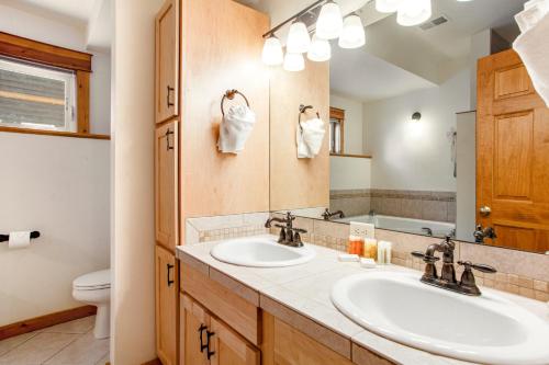 a bathroom with two sinks and a mirror at Estes Park Escape - Permit #6071 in Estes Park