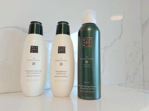 three bottles of hair products sitting on a counter at Studio Bink in Maastricht