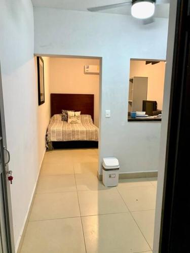 a bedroom with a bed and a tiled floor at Departamento Regiomontano in Monterrey