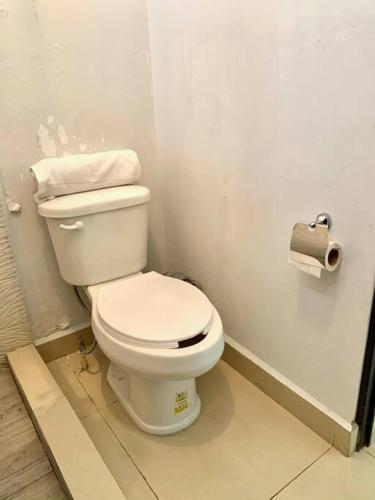 a bathroom with a toilet and a roll of toilet paper at Departamento Regiomontano in Monterrey