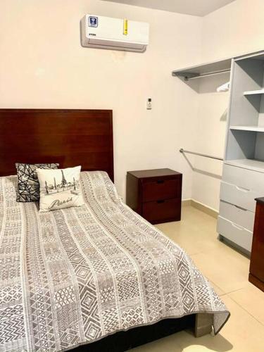 a bedroom with a bed and a dresser at Departamento Regiomontano in Monterrey