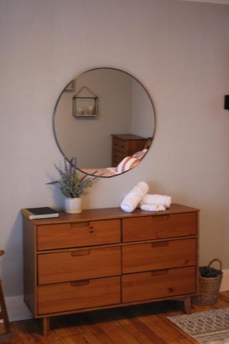 a dresser with a mirror on top of it at The Master Bedroom at the Hillside B&B in Wisconsin Dells