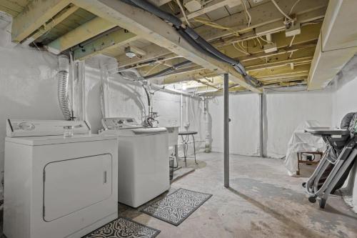 a laundry room with a washing machine and a sink at 3BR free parking free Wi-Fi near dntown St Paul in Saint Paul
