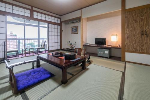 uma sala de estar com uma mesa e uma varanda em 8－1 - Vacation STAY 29661v em Kochi