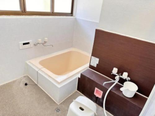 a bathroom with a tub and a toilet and a sink at Potato mura house tatara - Vacation STAY 90000v in Nagano