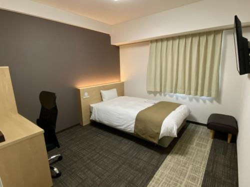 En eller flere senge i et værelse på Hotel Sunny Inn - Vacation STAY 20411v