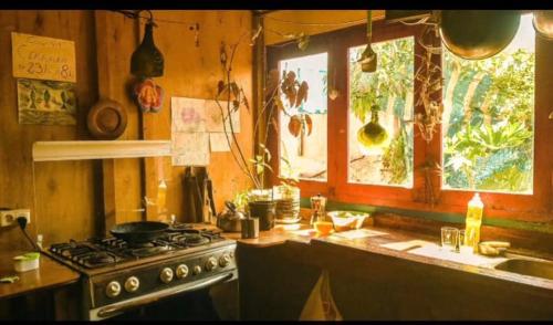 a kitchen with a stove and a window at Déja vú in Barra de Valizas