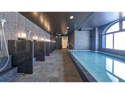 a large swimming pool in a building with a swimming pool at Welina Hotel Premier Nakanoshima West - Vacation STAY 22043v in Osaka