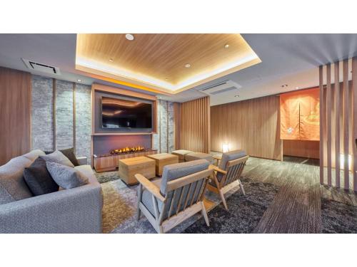 a living room with a couch and a fireplace at Welina Hotel Premier Nakanoshima West - Vacation STAY 22043v in Osaka
