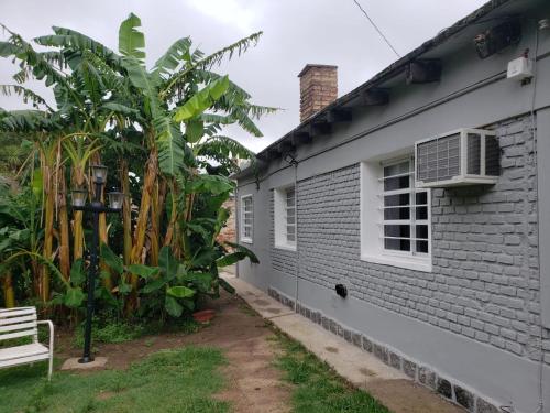 a white house with a window and a radiator at La casa de Clo in Villa Carlos Paz