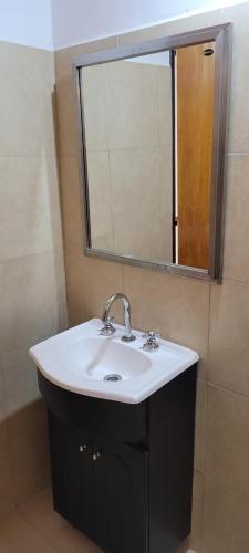 a bathroom with a sink and a mirror at ALQUILERES MARLUZ in Trelew