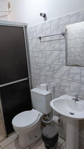 a bathroom with a toilet and a sink at Hotel Turazzi in Cáceres