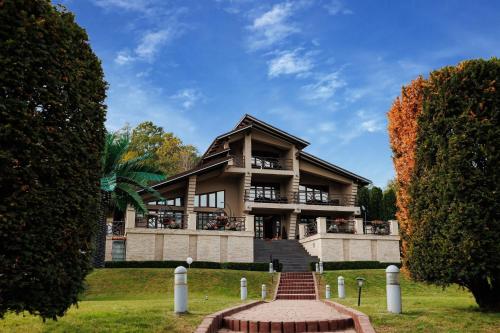 a building with a staircase in front of it at ANCA RESORT & SPA - Transilvania in Sălciua de Jos