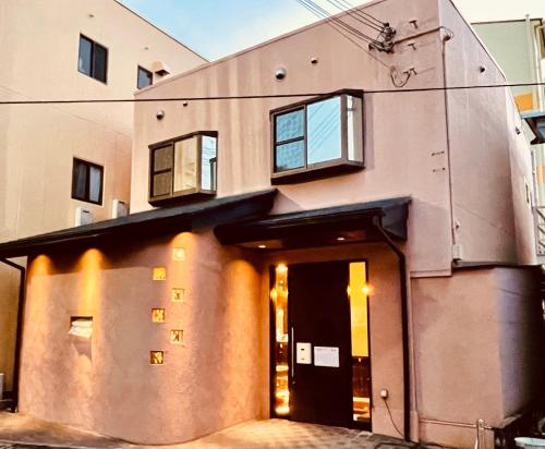 a building with a door and windows on it at 白浜乃風 Shirahama No Kaze in Kanayama