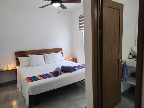 a bedroom with a bed and a ceiling fan at Blue Mahahual in Mahahual