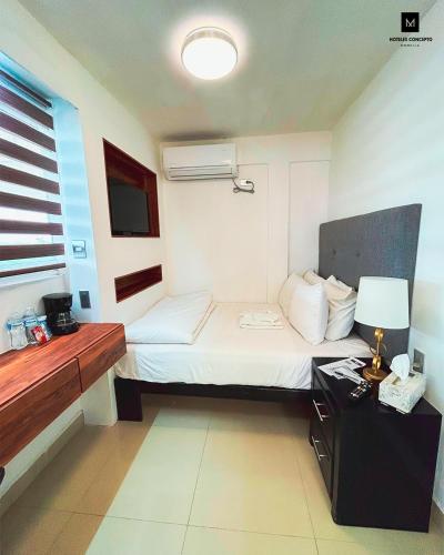 Ένα ή περισσότερα κρεβάτια σε δωμάτιο στο M Hoteles Concepto