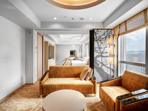 a living room with a couch and a table at Daiwa Roynet Hotel KANAZAWA-MIYABI in Kanazawa