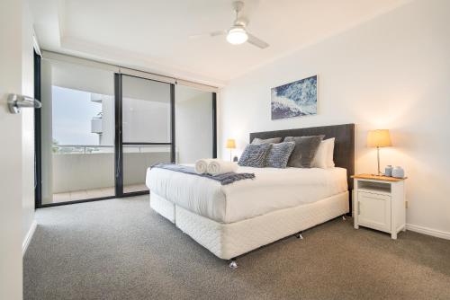 a bedroom with a bed and a large window at Riverside Retreat! Beautiful Water Views! - New Farm in Brisbane