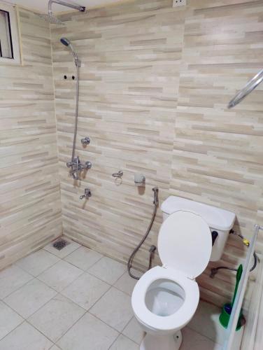 a bathroom with a toilet and a shower at Araliya Uyana Residencies Colombo - Entire House with Two Bedrooms in Colombo