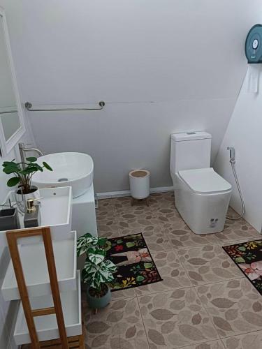 a bathroom with a toilet and a sink at สวนเบอร์รีแคมป์ทนายจุฬา Berry Camp Korat in Ban Nong Khon
