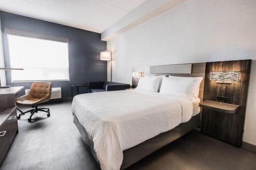 a bedroom with a bed and a desk and a chair at Holiday Inn Express Toronto-North York by IHG in Toronto