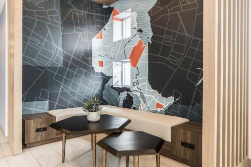 a room with a table and two chairs and a wall at Holiday Inn Express Toronto-North York by IHG in Toronto